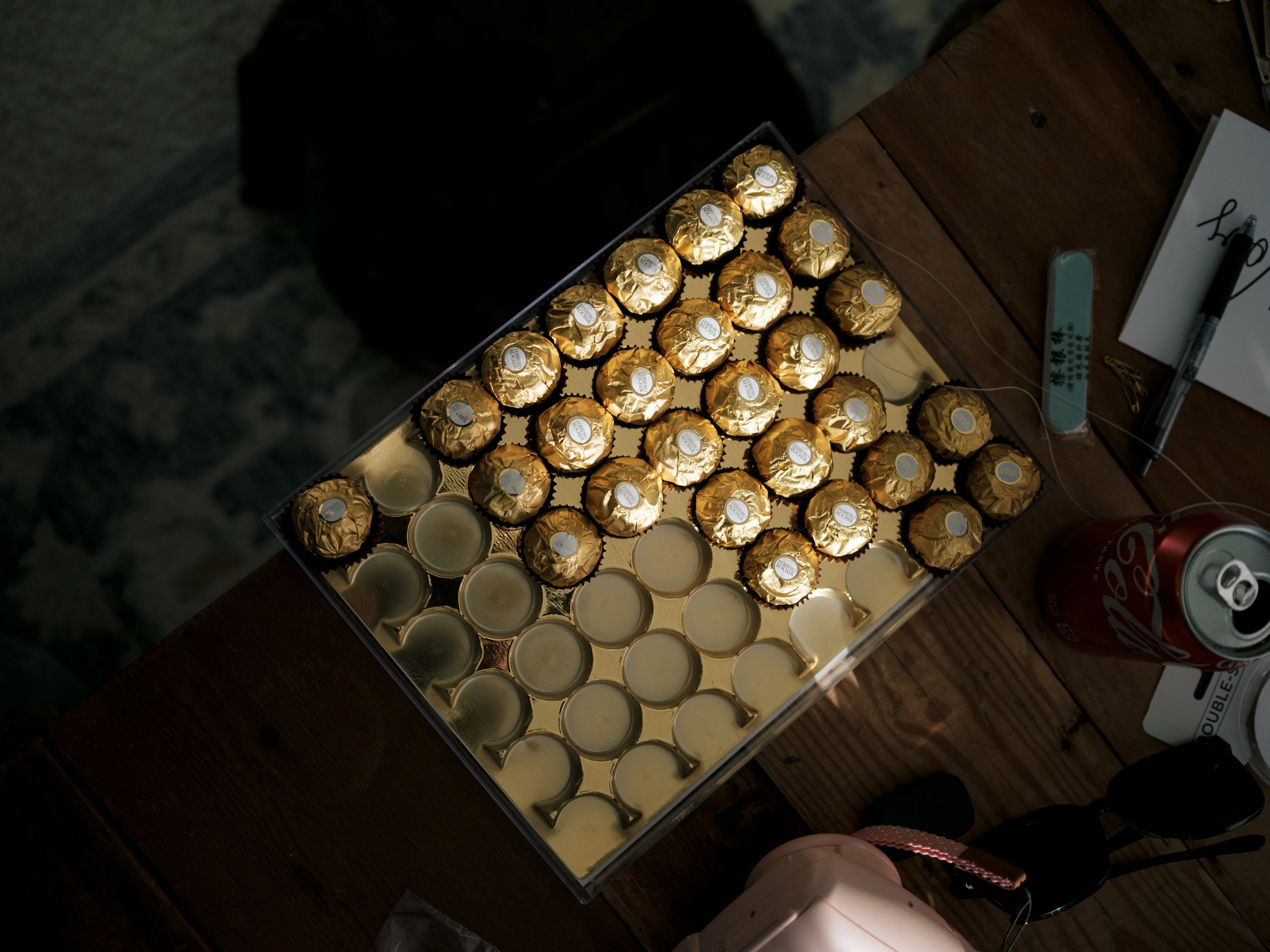 Multiple images show the process of making honey vanilla custard in glass jars with lit candles on top.