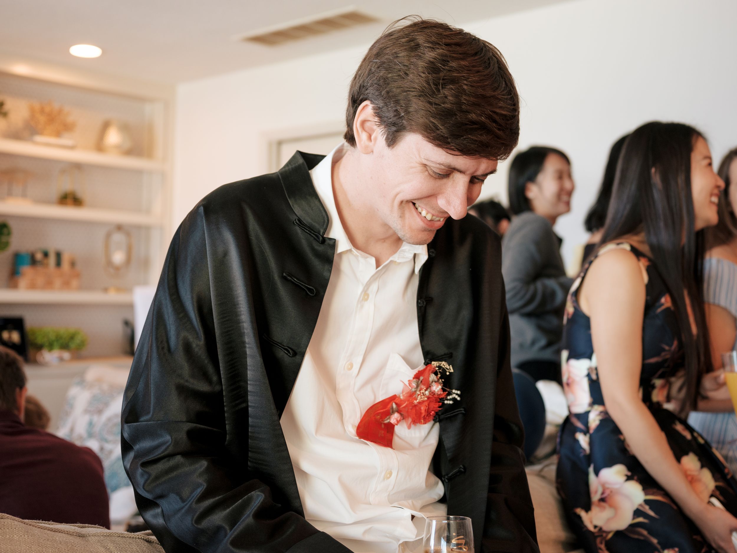 Guests in formal attire mingling at an elegant indoor celebration.