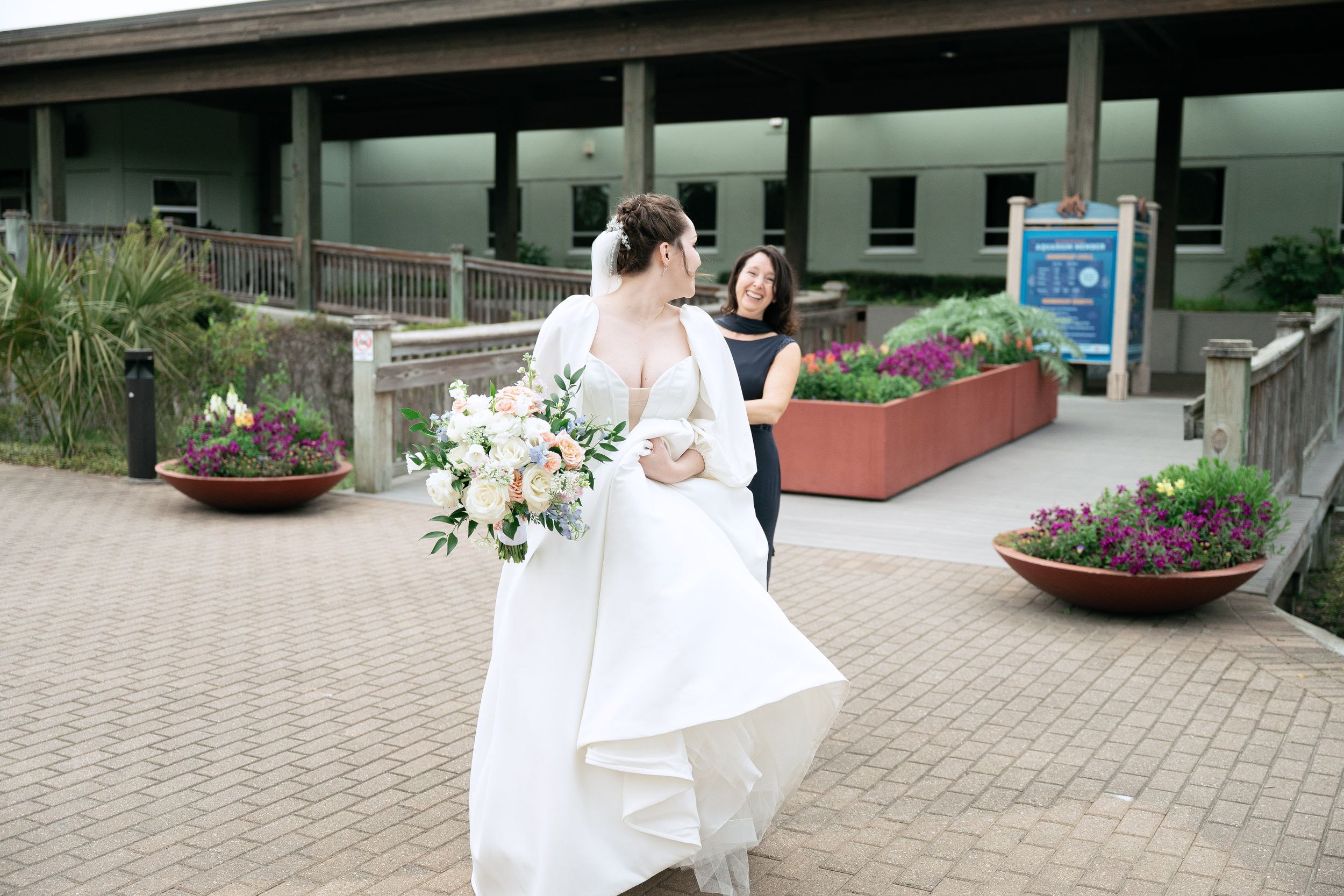 Wedding party exits ceremony venue on brick pathway with sparklers creating magical nighttime sendoff celebration.