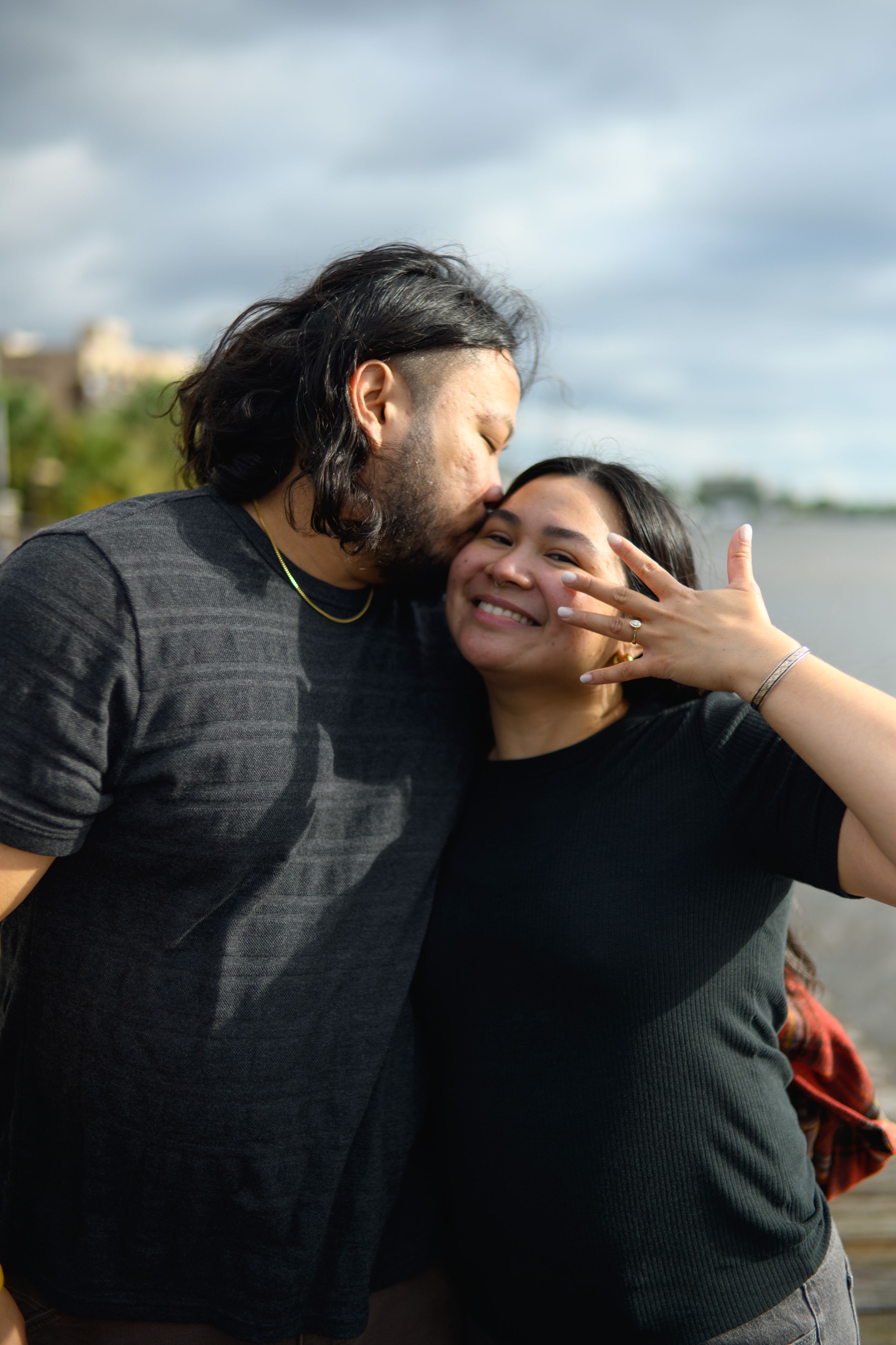 A sequence of candid photos showing two people embracing and sharing a playful moment outdoors.