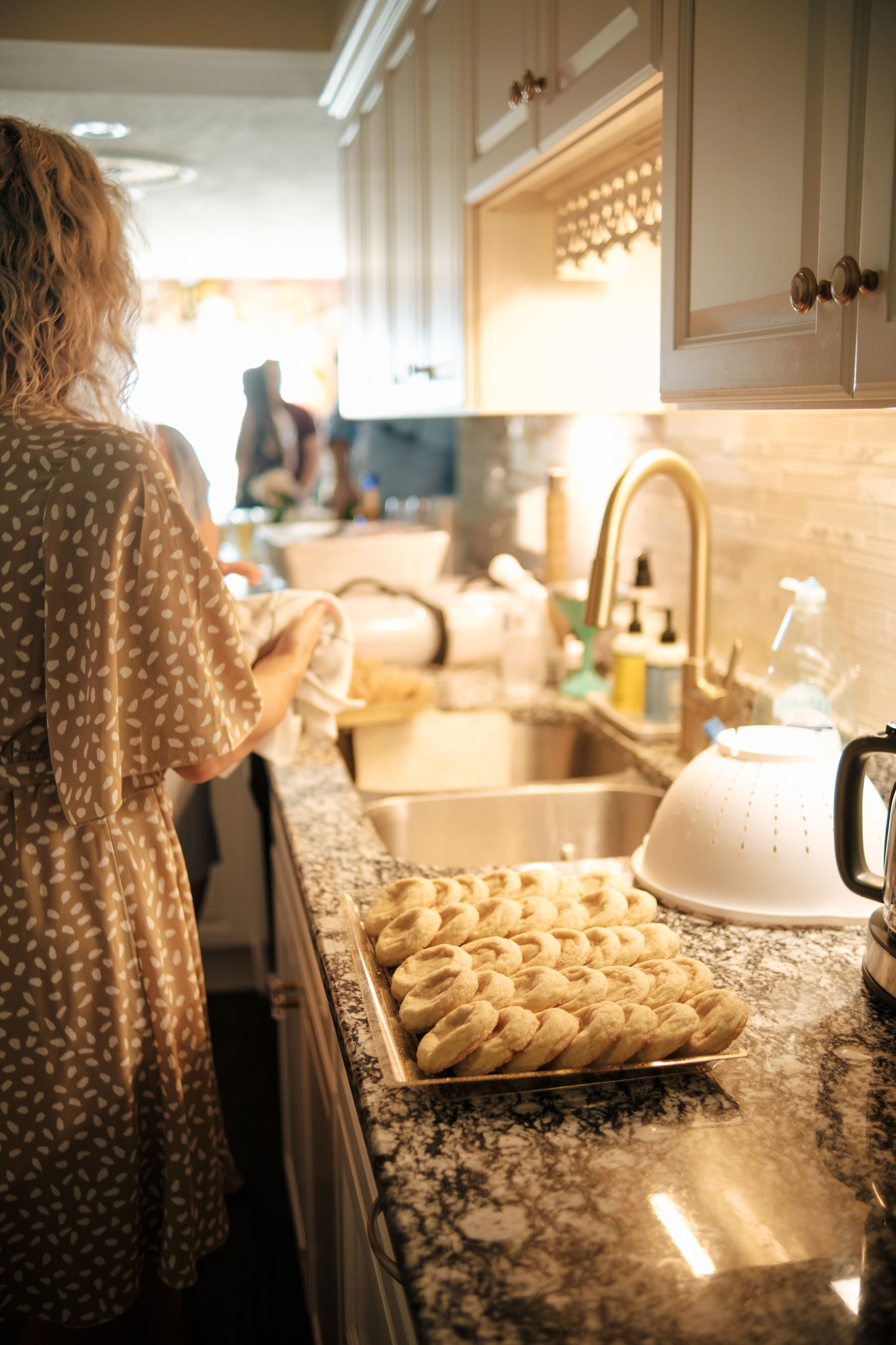 Sunlit kitchen counter with freshly baked bagels and leopard print fabric in view.
