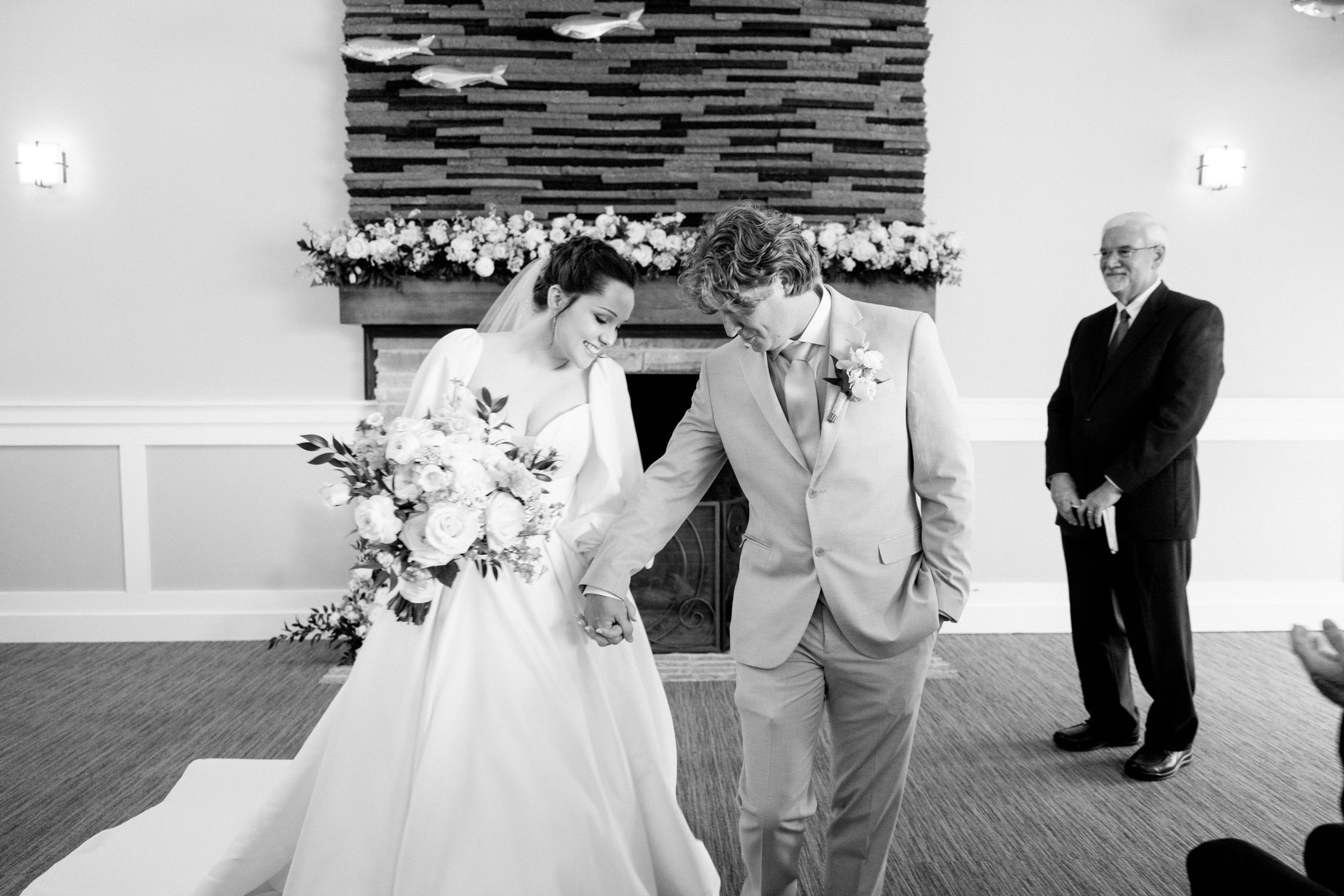 A tender moment at an outdoor wedding venue with guests gathered during the ceremony.