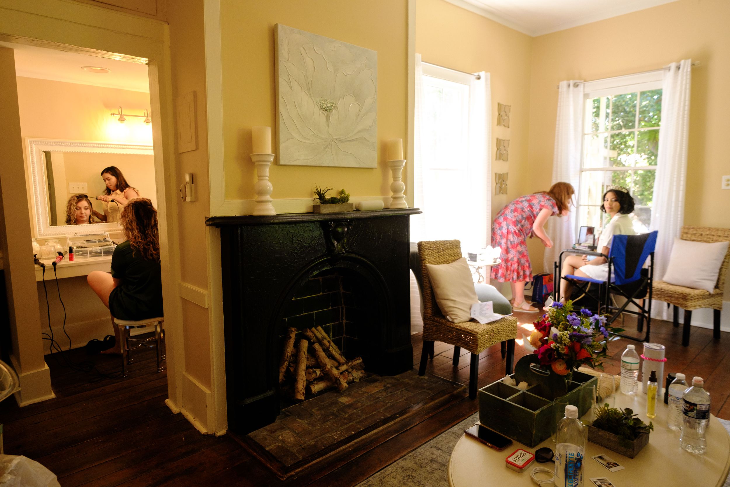 A panoramic view of a bright home interior showing multiple connected rooms with white walls and natural lighting.