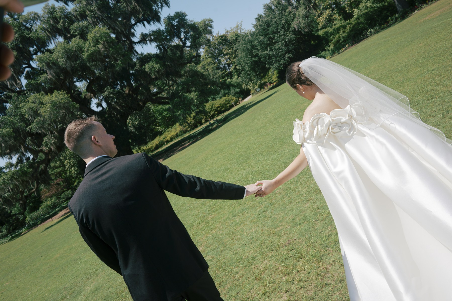 Lizzy and her partner holding hands while moving across the lawn