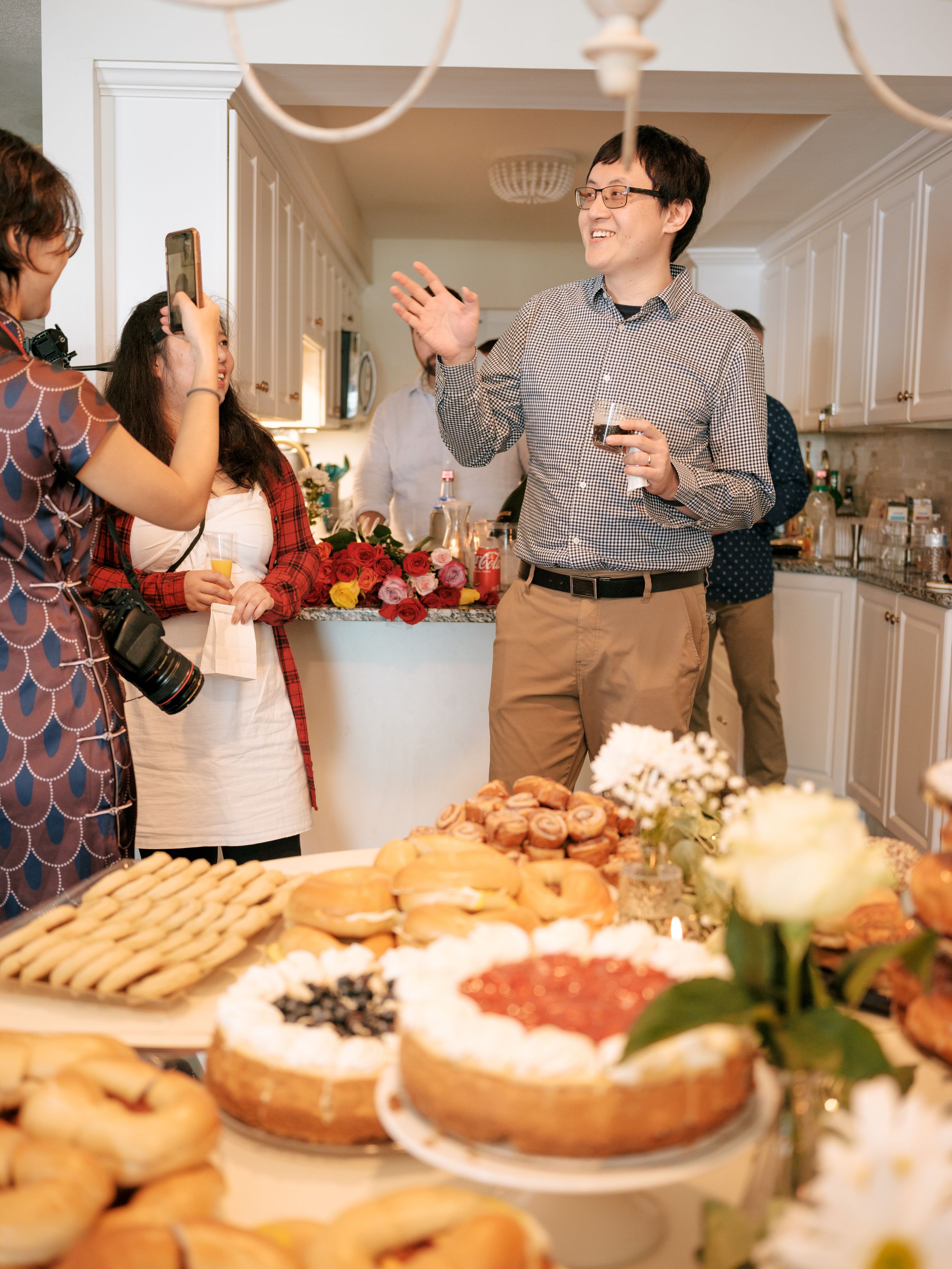 Elegant dessert buffet at an upscale reception displaying cakes, pastries and sweets on a white tablecloth.