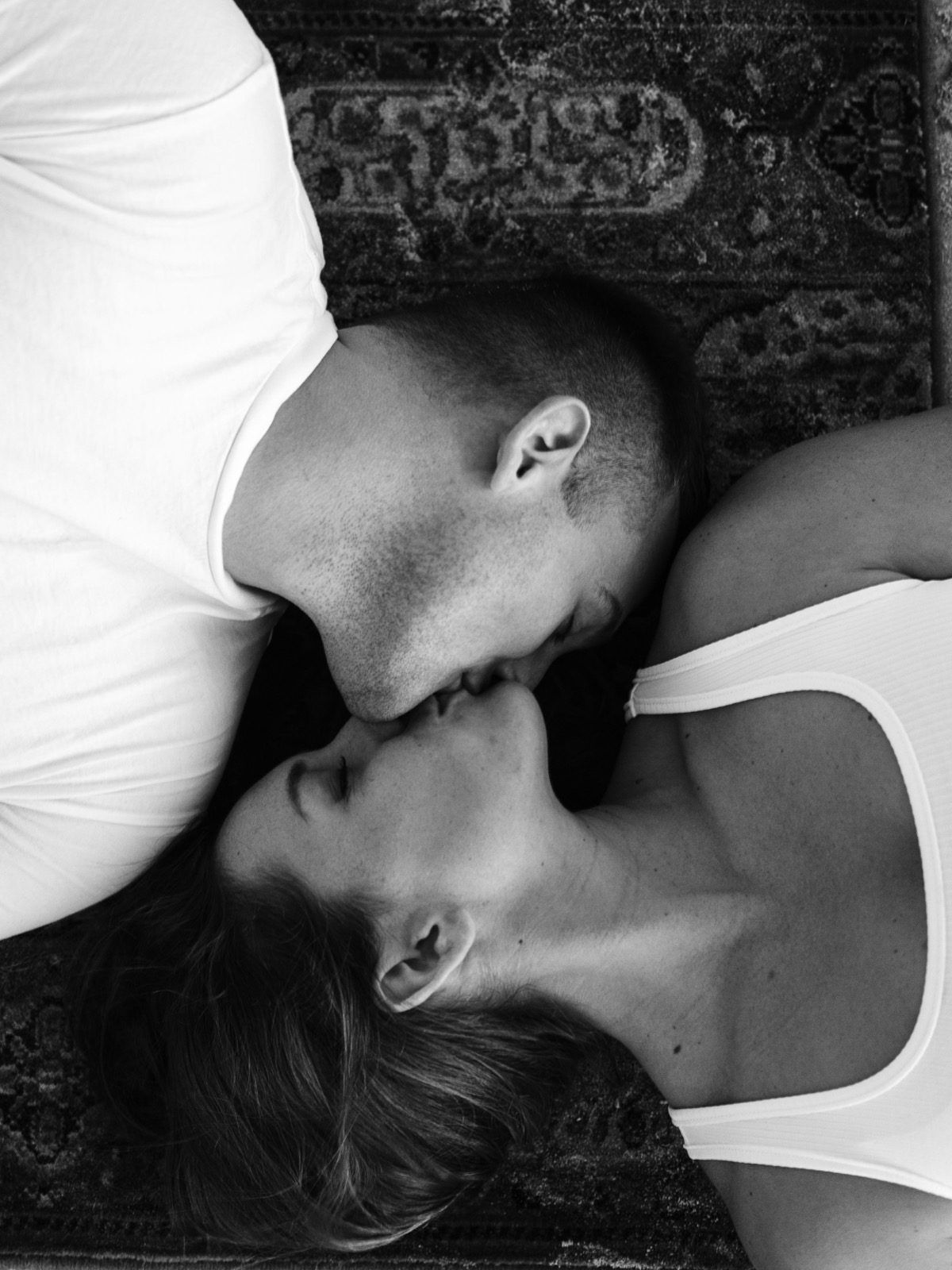 couple kissing each other on the sand