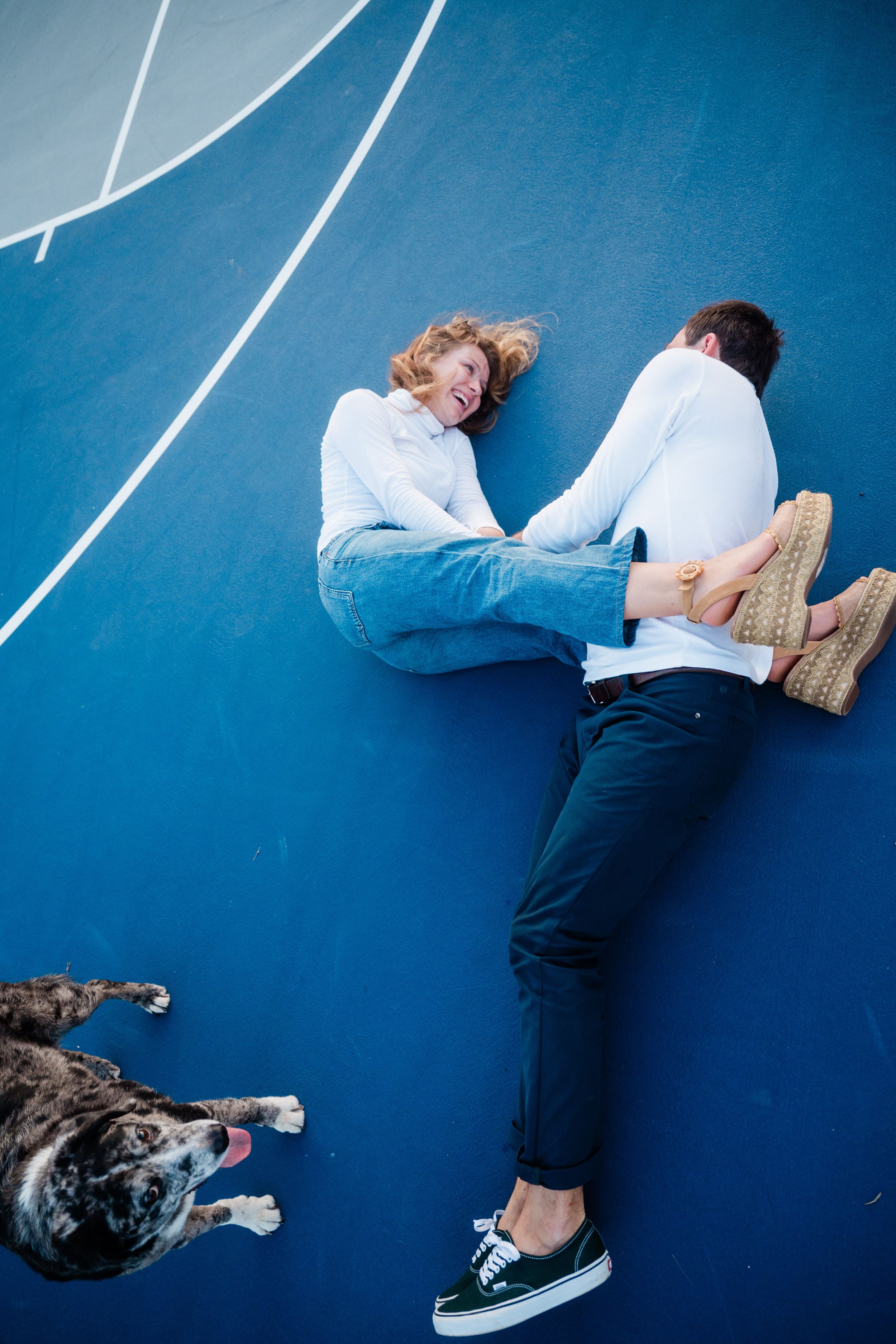 Person lying against blue wall with dog in artistic photo sequence.