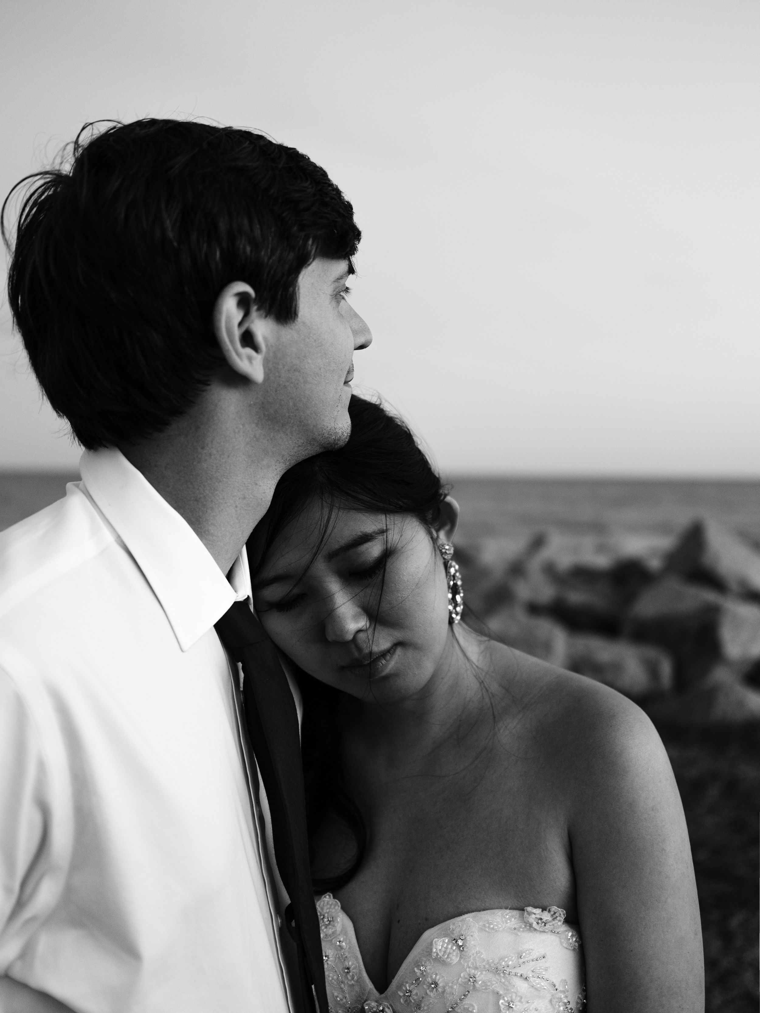 A black and white photo series of a couple in wedding attire sharing intimate romantic moments together.