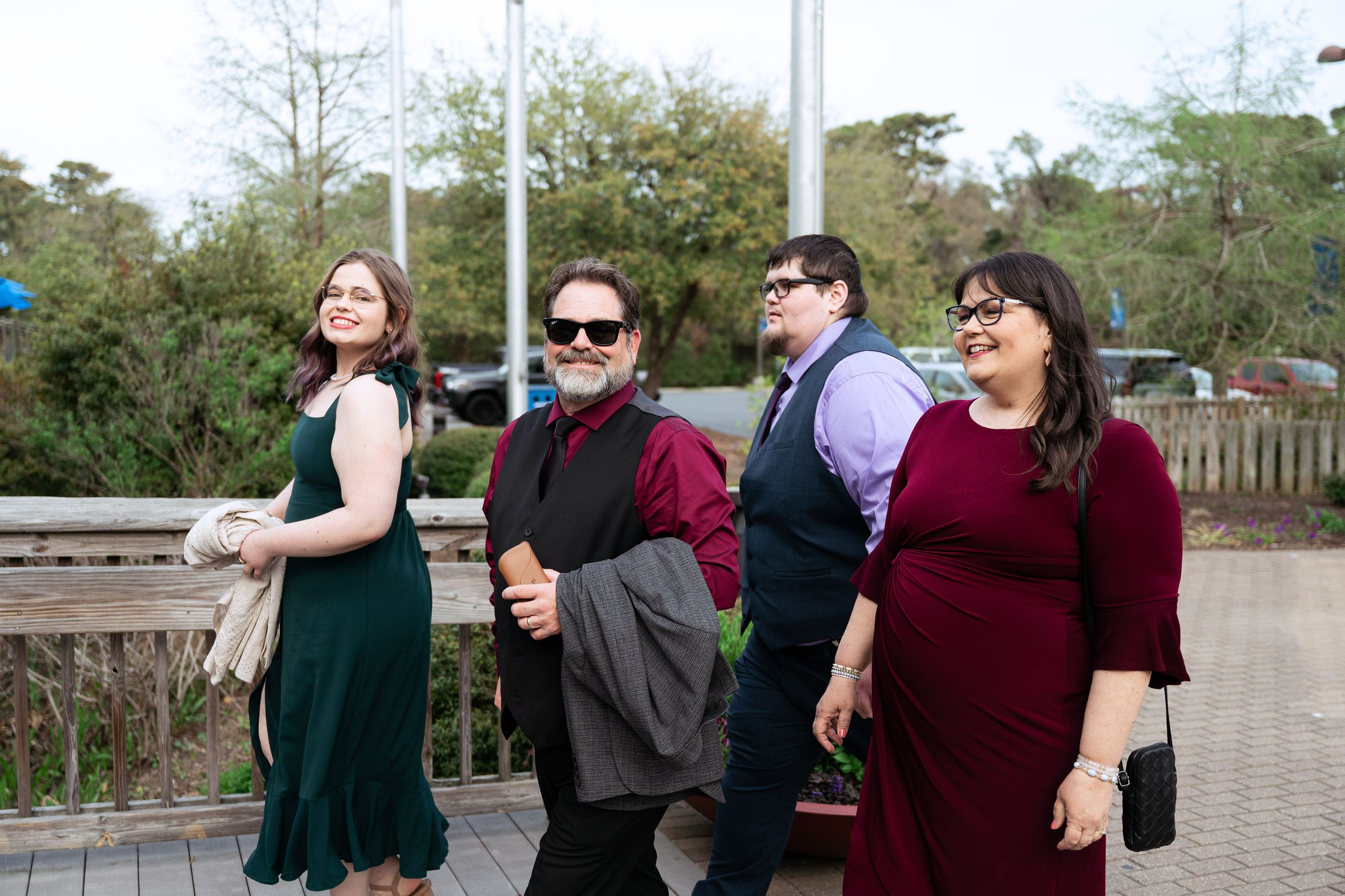 Wedding attendees gather and socialize on an outdoor patio during a celebration.