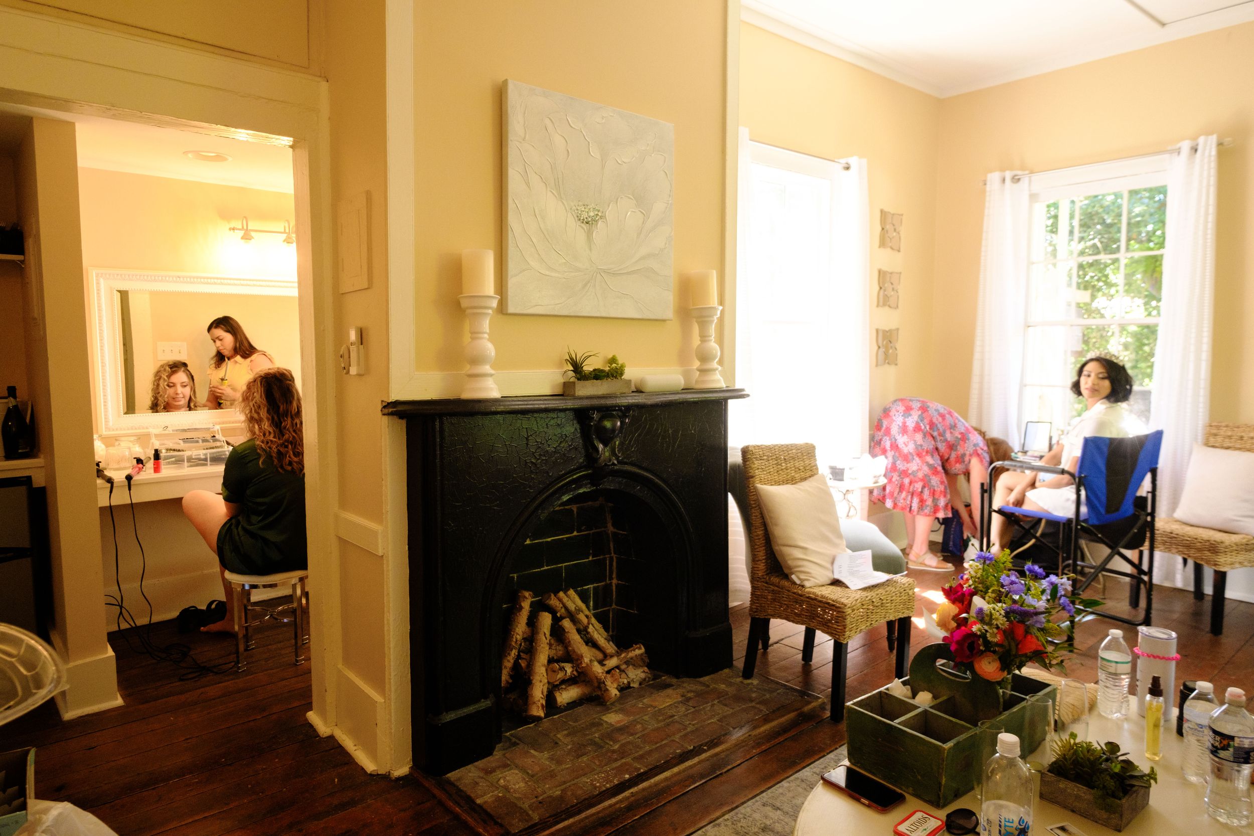 An elegant room interior with hardwood floors features multiple windows, white walls, and classical architectural details.