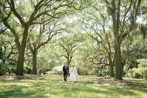 A couple framed by the oak trees at Airlie Gardens