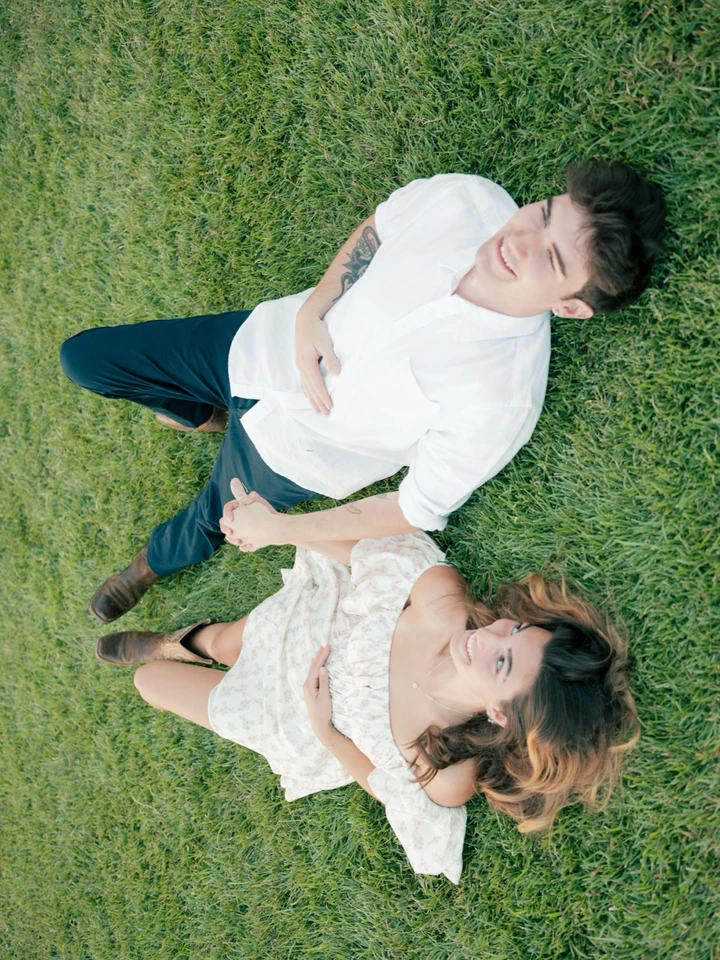 couples lying down the grass