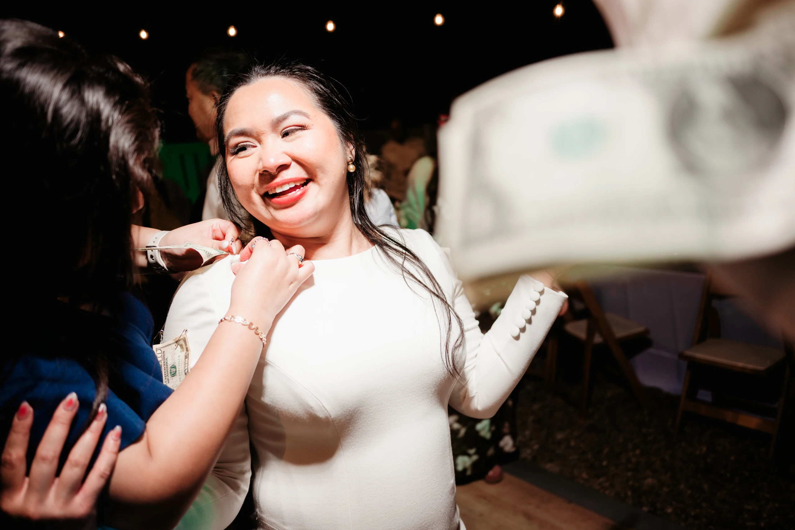 A couple shares a romantic moment against a brick wall backdrop as golden sunlight casts dramatic shadows.