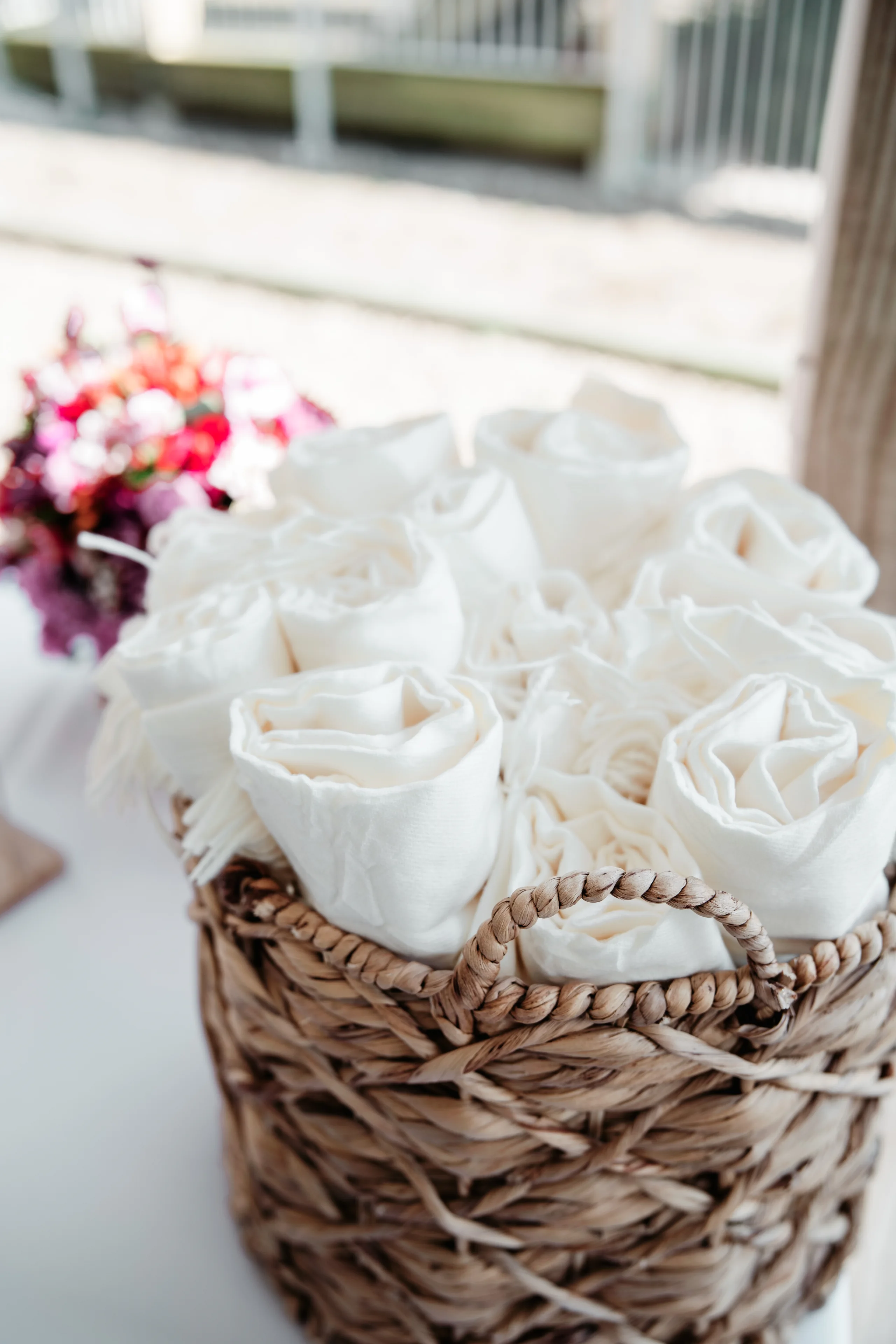 A romantic wedding couple shares an intimate moment in front of a beautiful brick mansion with white columns.