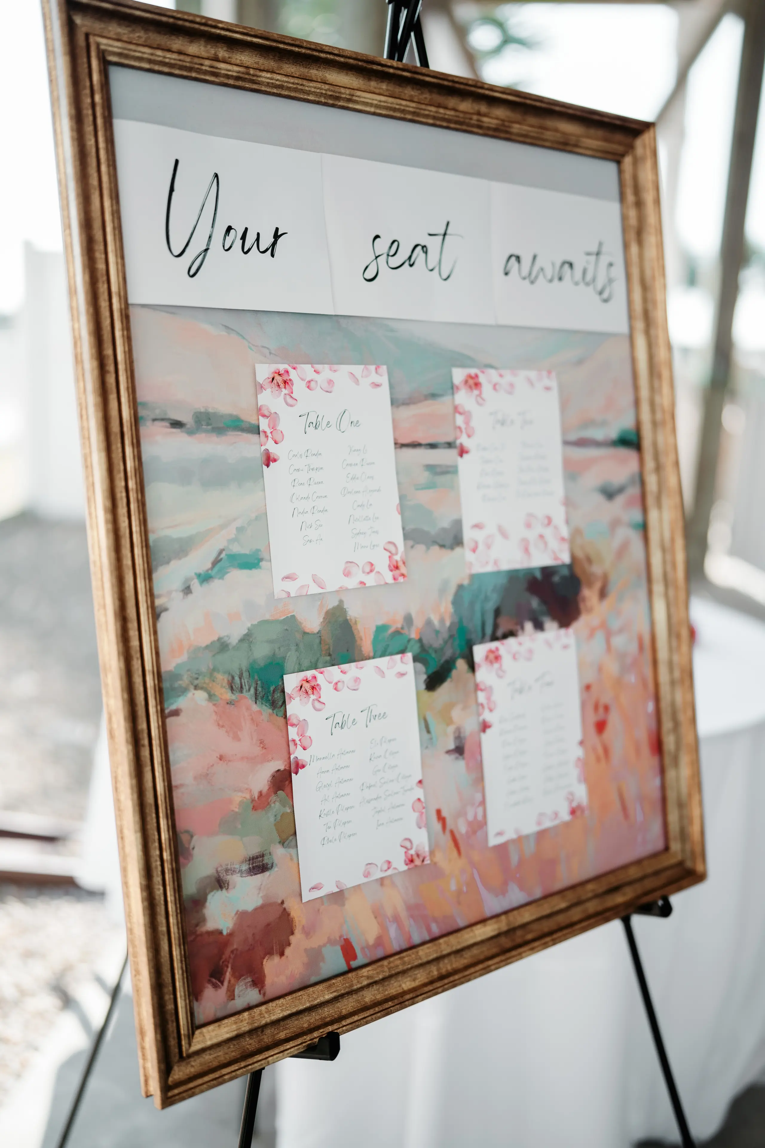 Vintage-style ornate street lamp post with green and white details against a soft blue sky.