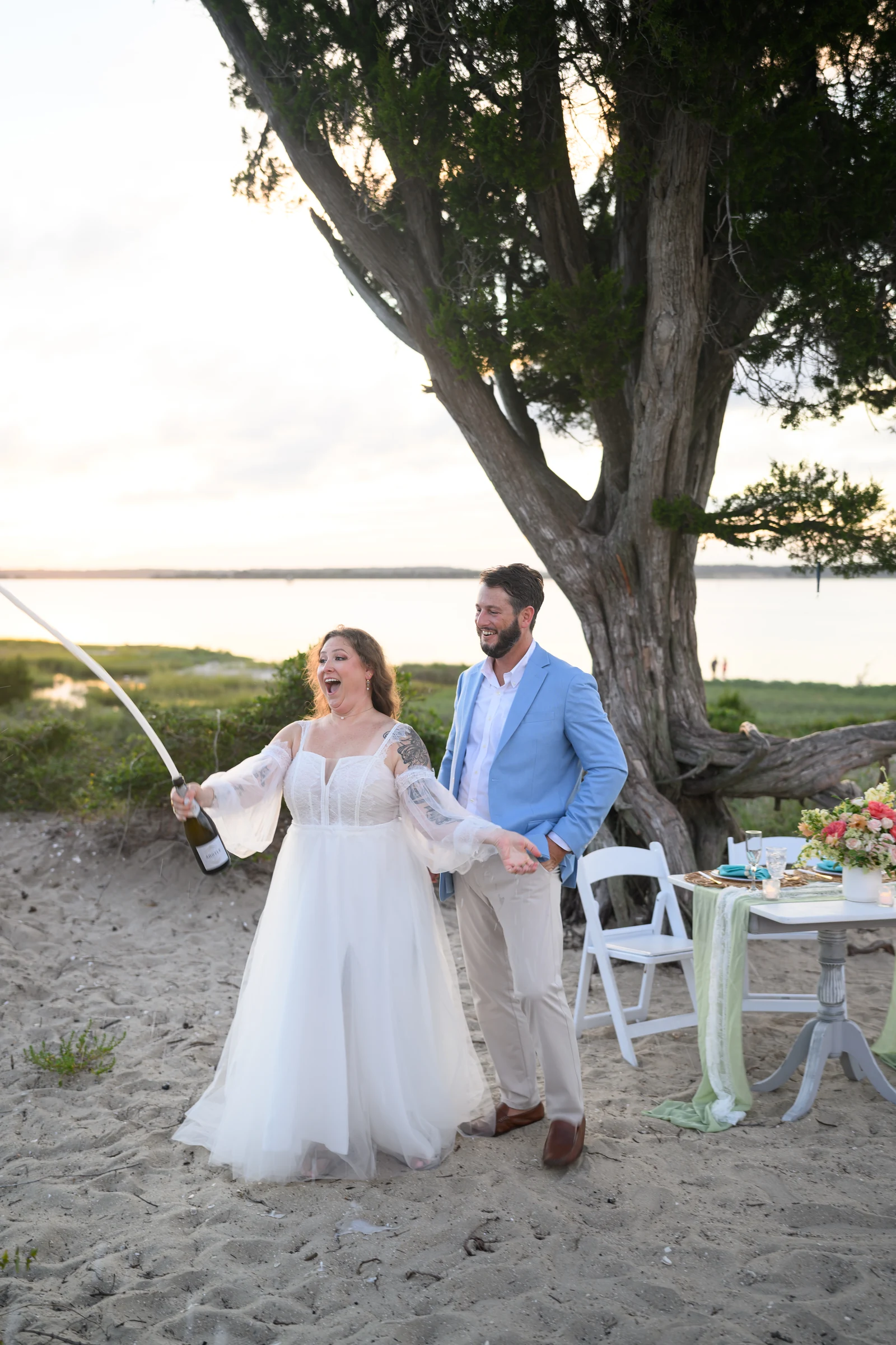 Celebrating their anniversary with a champagne spray beneath the tree.