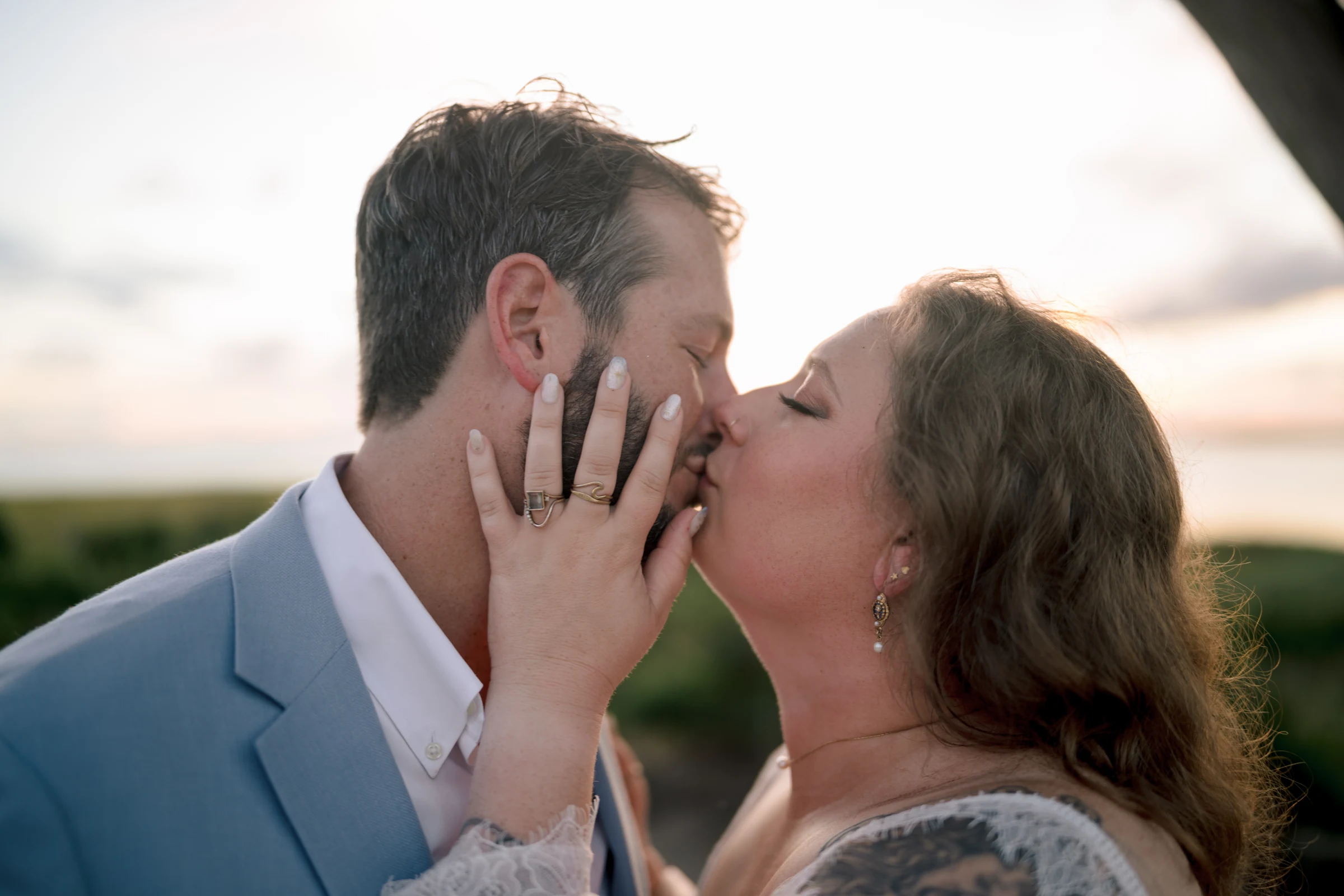 A close portrait of Bryan and Dev sharing a kiss.