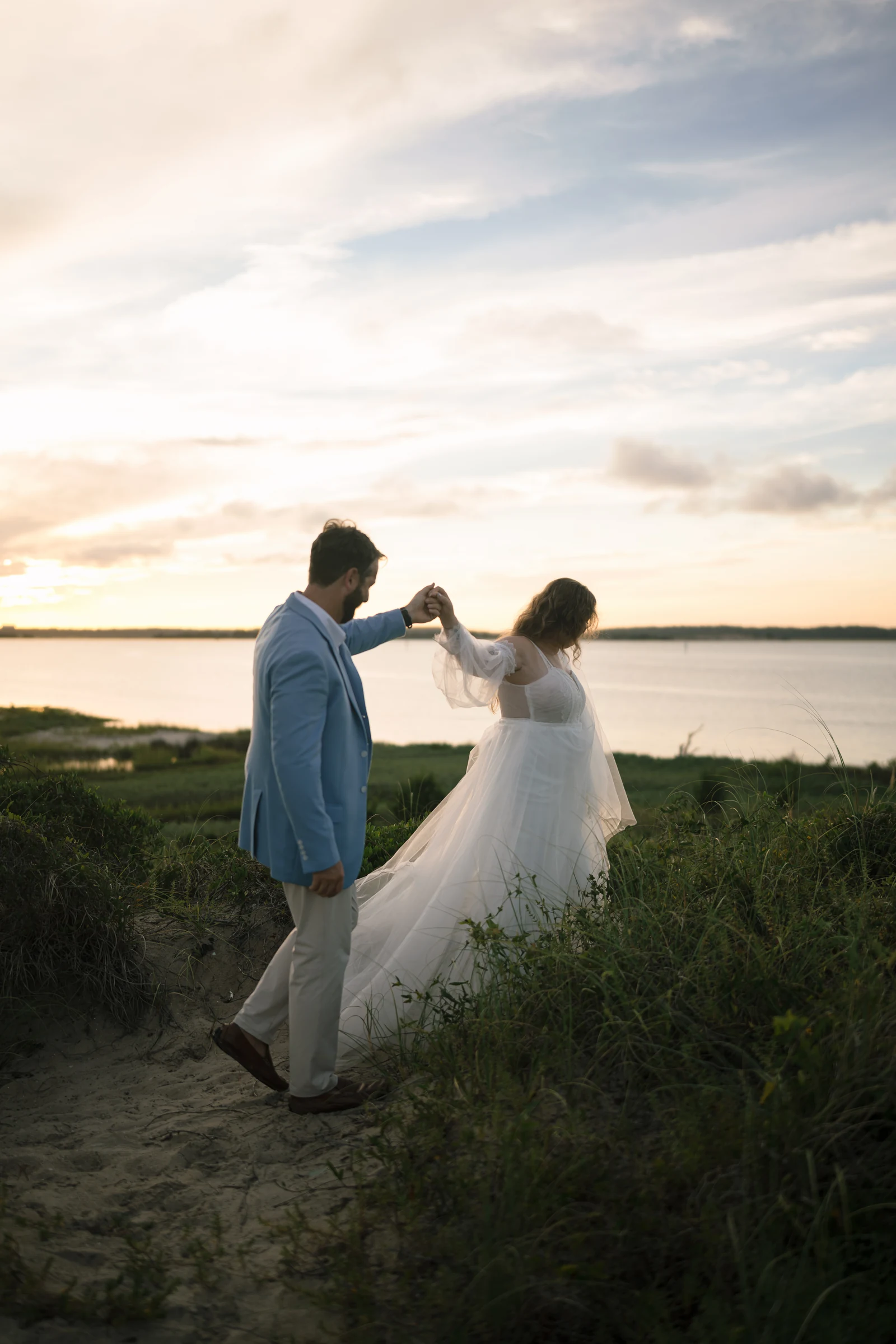 Bryan and Dev twirling beside the water at sunset near Fort Fisher Mailbox.