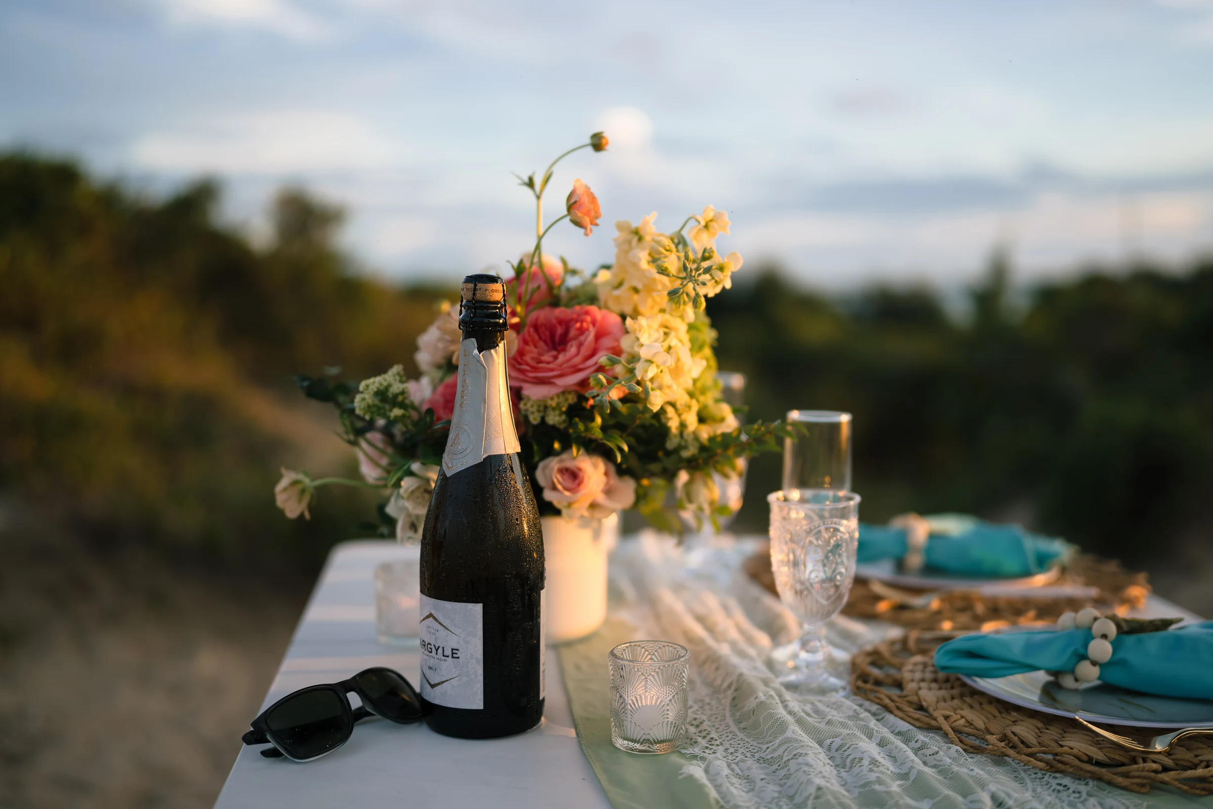 Champagne, flowers and the table setting for their anniversary celebration.
