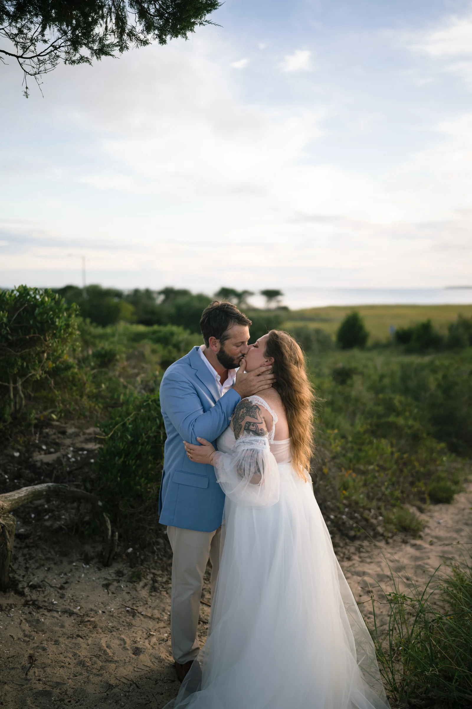 Bryan and Dev sharing a kiss during their Fort Fisher anniversary session.